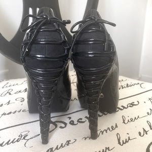 Sexy twist on a black pump. Lace up the back. Platform
